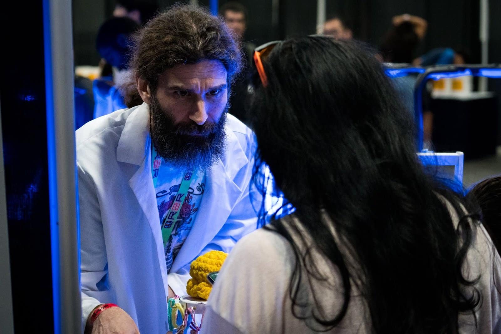 Man staring intensely interacting with lady who is learning about product.