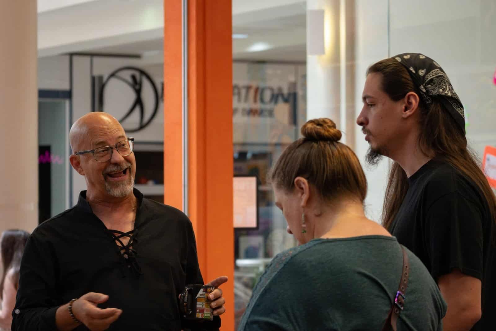 Photograph of Windmill Studios' owner interacting with clients on their grand opening day.