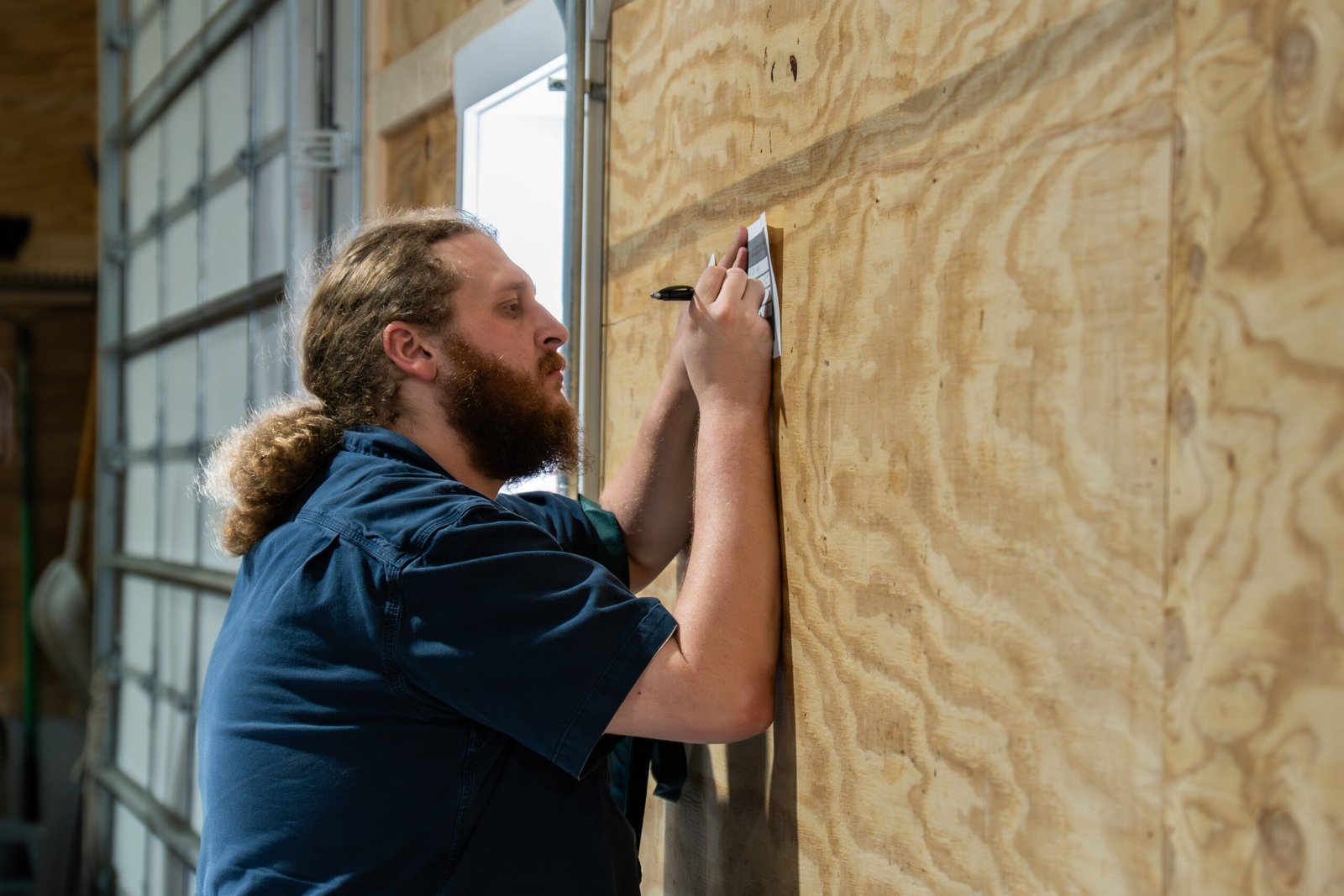 Photograph of man at registration along a wall at an expo event