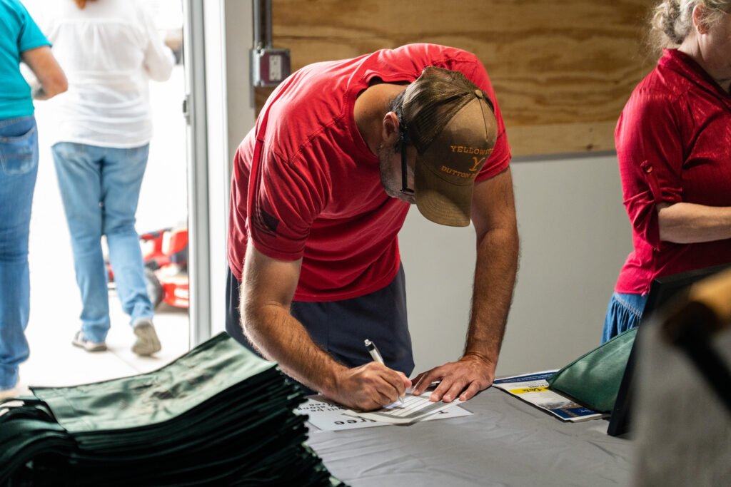 Photograph of man at registration at a business event