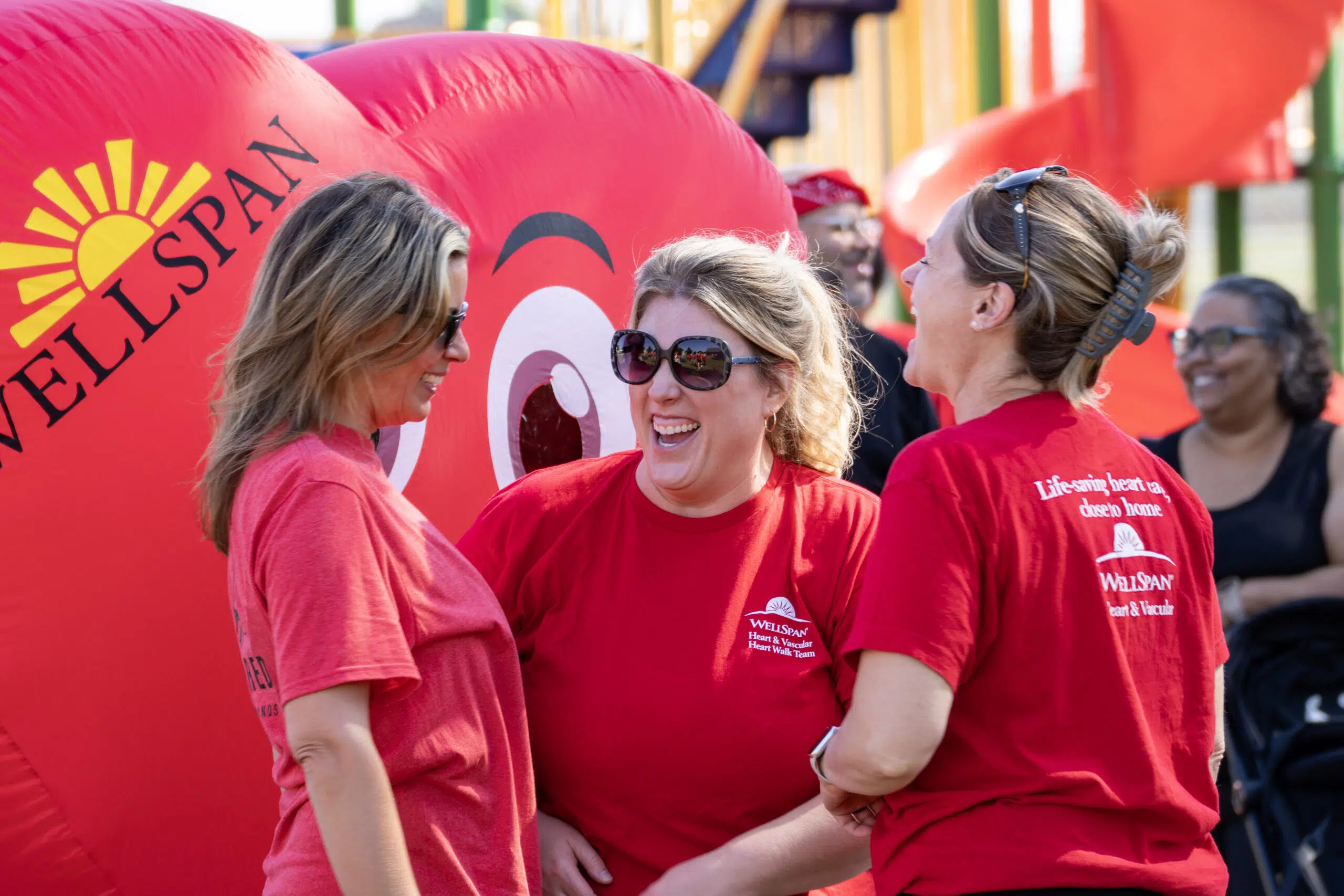 Candid photograph of a Group of ladies interacting with each other having a good time.