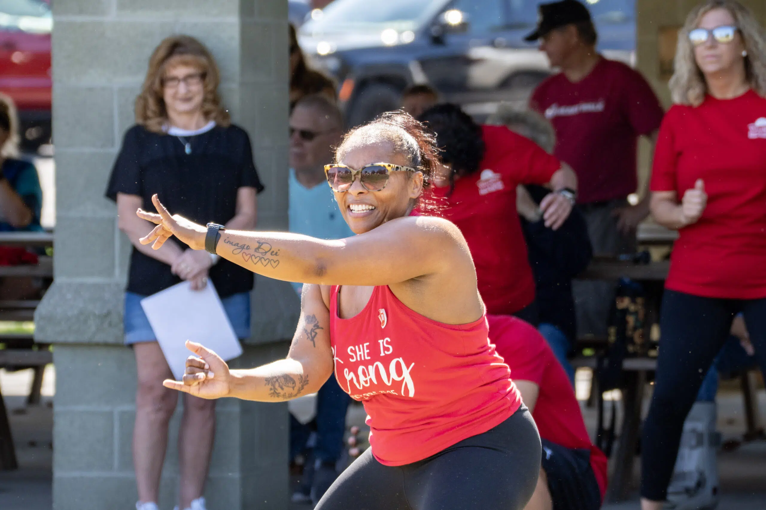 Lady dancing in front a of group of people at a events.