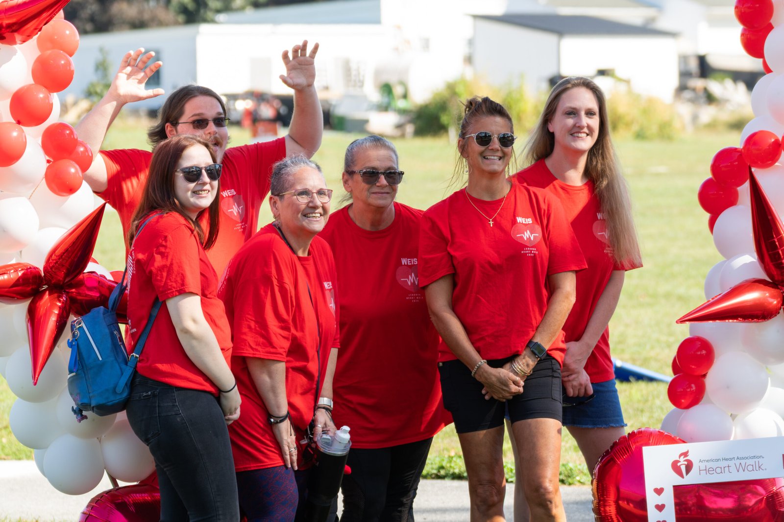 Event sponsor staff grouped up with each other to take a group photo with each other.
