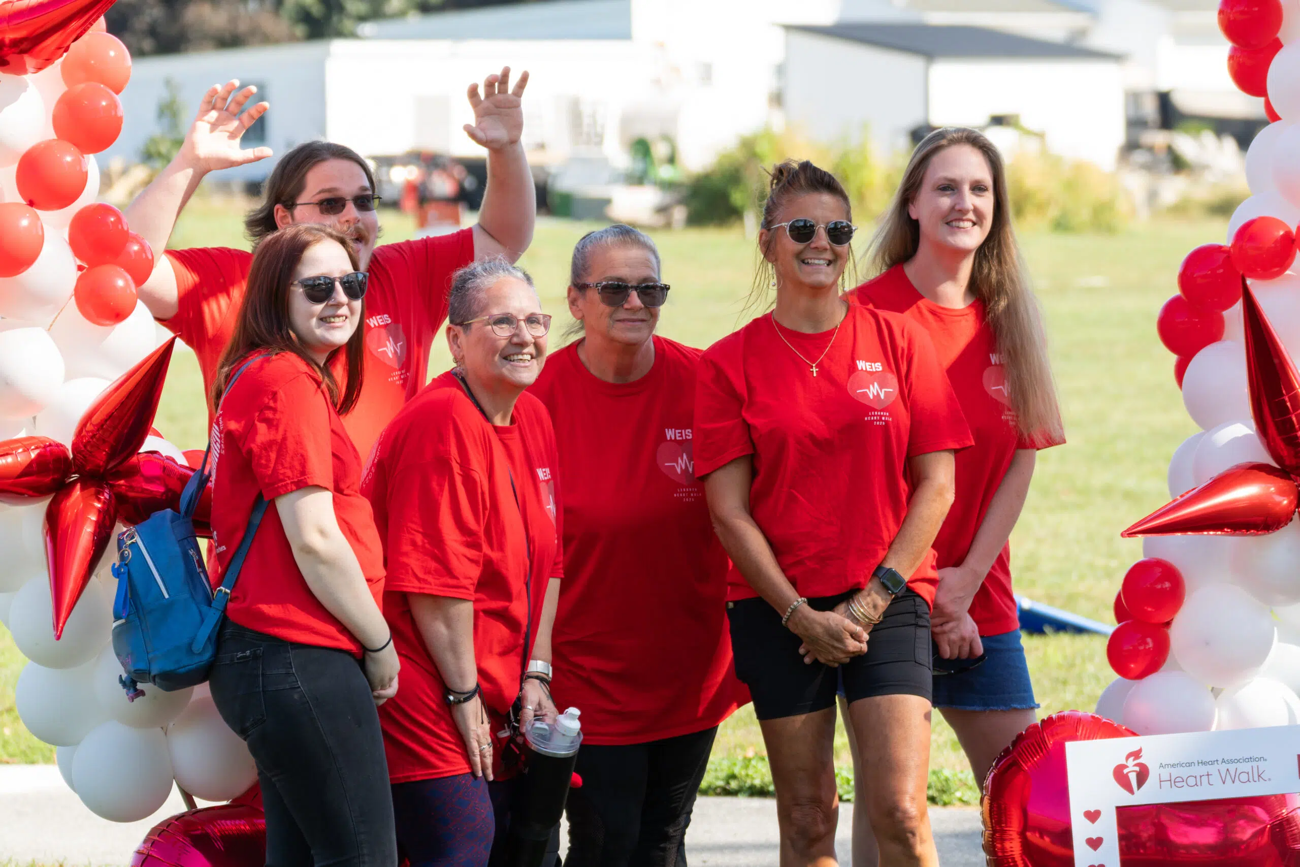 Event sponsor staff grouped up with each other to take a group photo with each other.