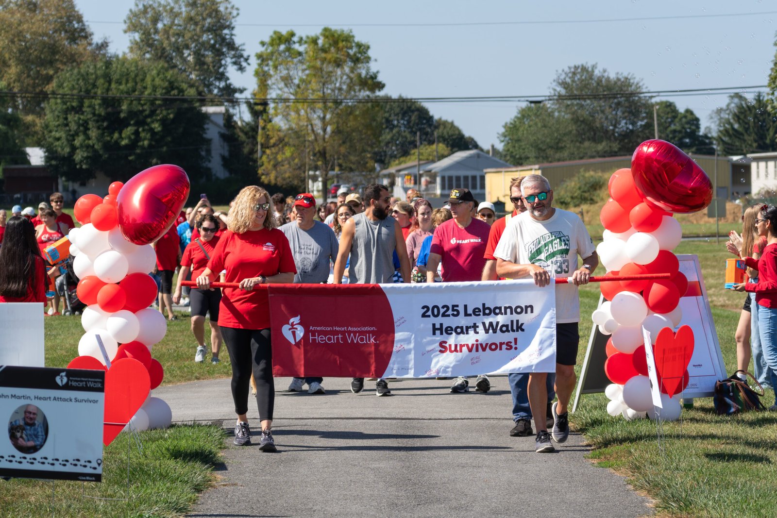 two speaker holding a lebanon heart walk sign as the event starts.
