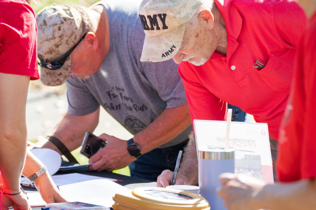 Photo of 2 guys registering for walking event.