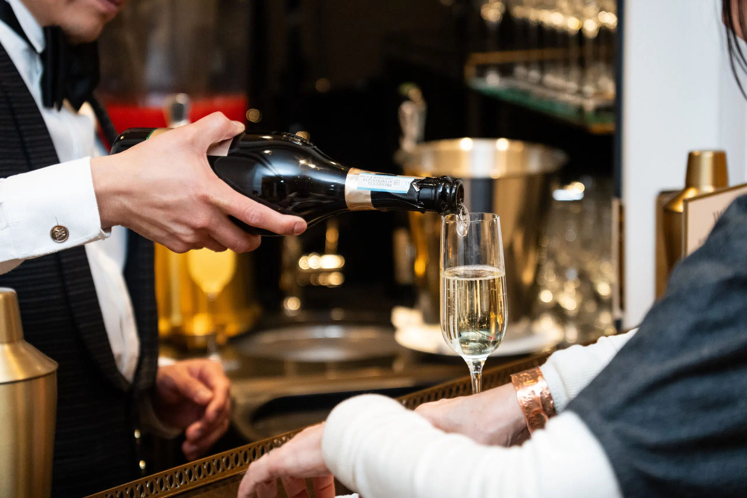 Catering at an event pouring wine to guest