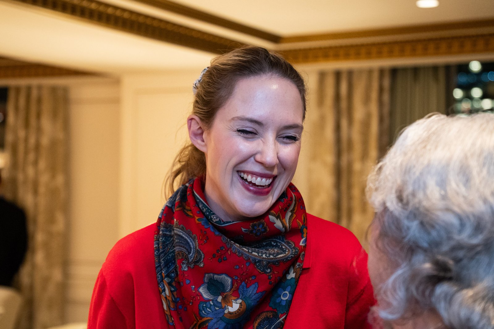 Candid interaction of lady laughing having a good time at an event