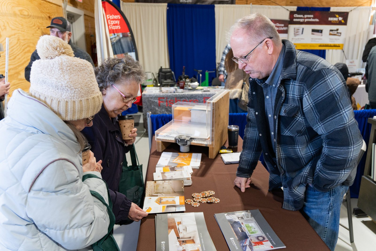 Attendees stoping at a booth to learn about a product.