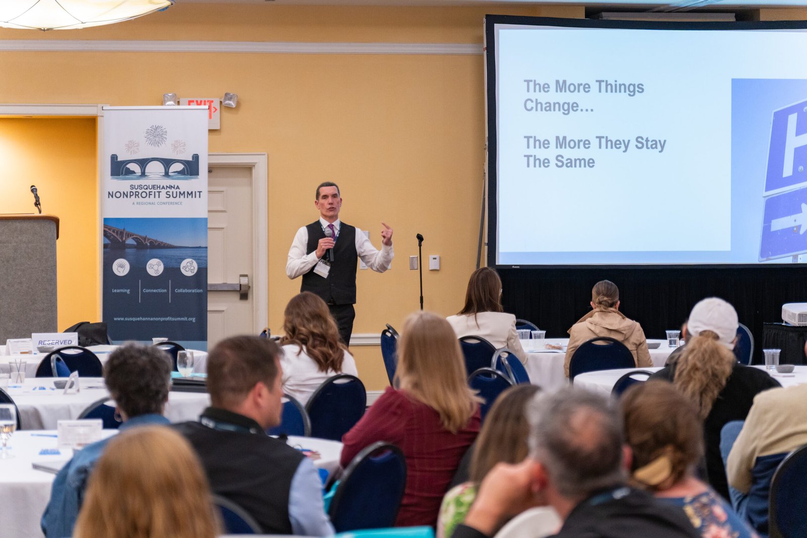Photograph of speaker talking at a NON profit event