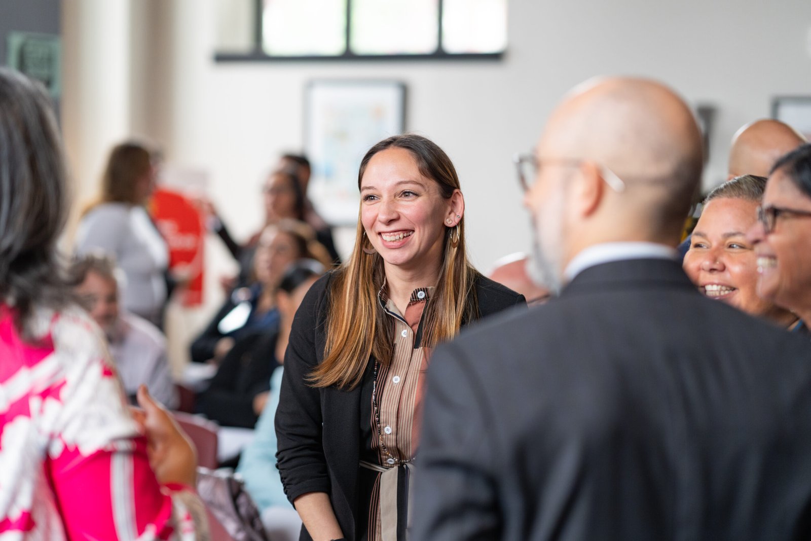 Photograph of women laughing at a UNIDOS US event